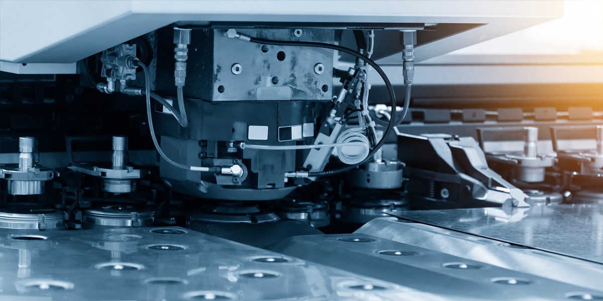 Close-up of the CNC punching machine in the light blue scene.Hig